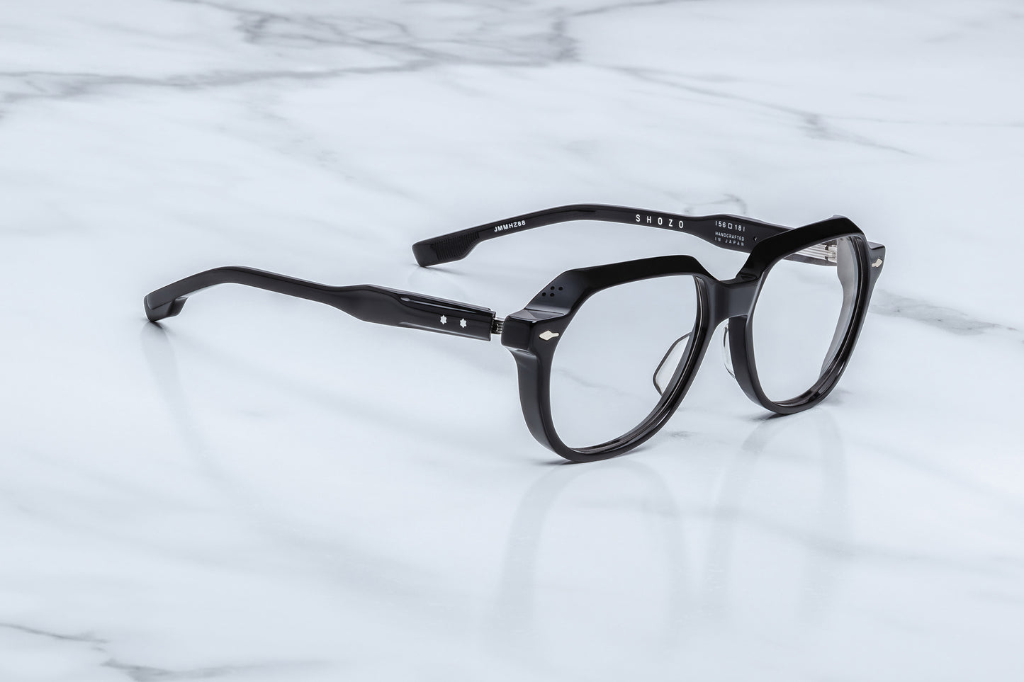 Jacques Marie Mage Shozo black optical frame side view showing thick acetate temples, exposed wire core and premium hinge detail
Side profile of JMM Shozo black eyeglasses highlighting sculptural temples and silver hardware