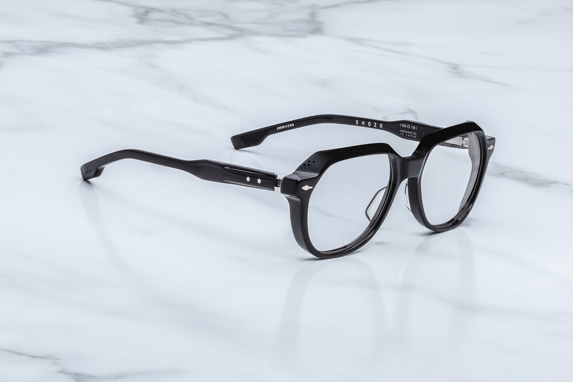 Jacques Marie Mage Shozo black optical frame side view showing thick acetate temples, exposed wire core and premium hinge detail
Side profile of JMM Shozo black eyeglasses highlighting sculptural temples and silver hardware