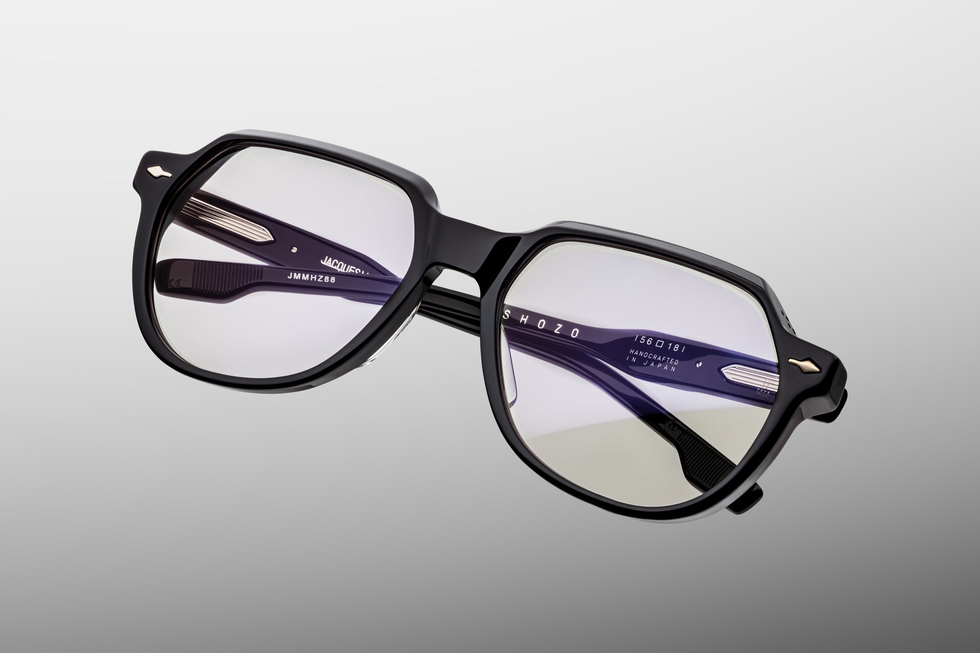 Close-up front detail of Jacques Marie Mage Shozo black frame showing arrowhead rivets, flattop brow and polished acetate finish
Macro front view of JMM Shozo black eyeglasses highlighting round lens shape and luxury craftsmanship