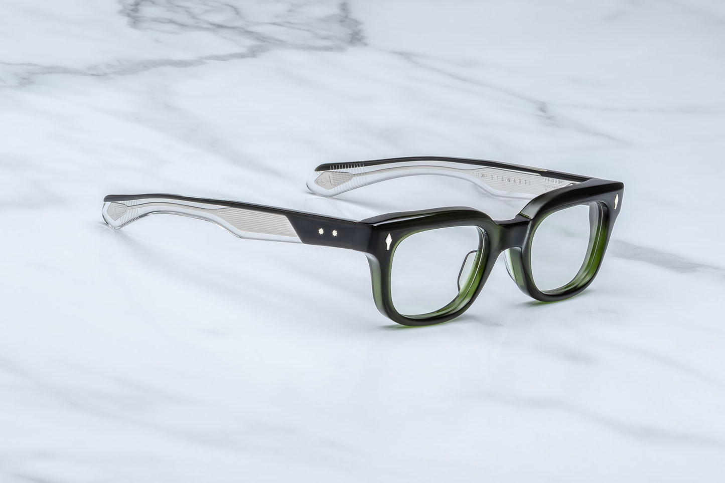 Jacques Marie Mage Stewart Borneo side view showing long tapered green acetate temples, exposed wirecore and 5-barrel hinge detail
Side profile of JMM Stewart Borneo eyeglasses highlighting mid-century design and premium acetate construction
