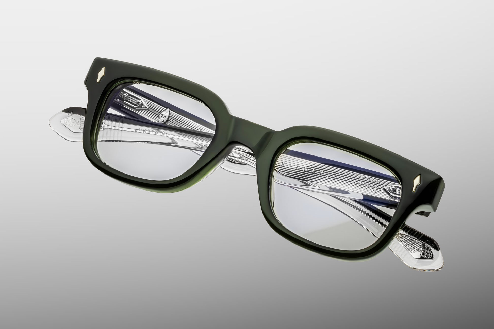 Close-up front detail of Jacques Marie Mage Stewart Borneo frame showing bevelled edges, arrowhead pins and polished green acetate finish
Macro front view of JMM Stewart Borneo glasses highlighting rectangular lens shape and handcrafted detailing