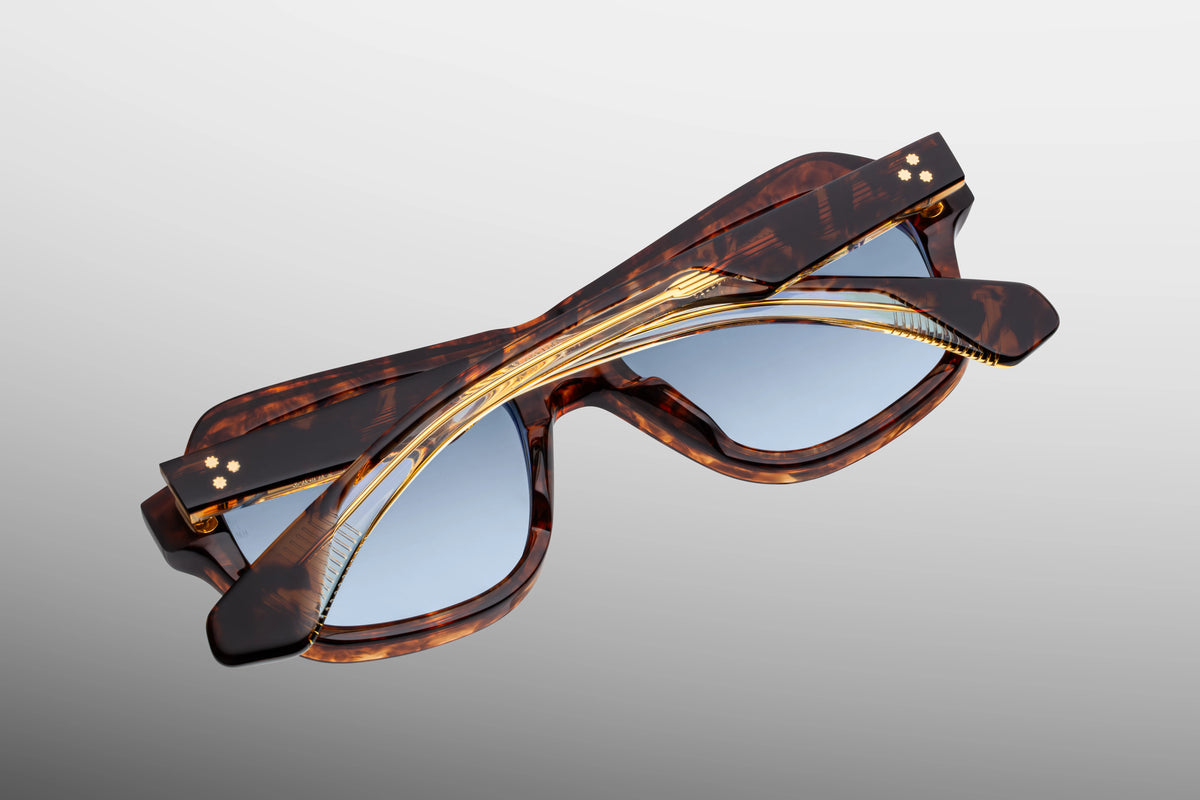Inner rear view of Jacques Marie Mage Tamerlis sunglasses, detailing the heavy-duty 7-barrel hairline hinge with spur-shaped rivets and the limited-production batch number foil-stamped on the interior temple arm.