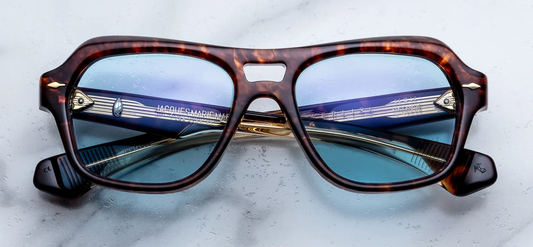 Front view of Jacques Marie Mage Tamerlis sunglasses. Displays a bold, late-1990s-inspired modified square frame with an aggressive, heavily beveled brow line, a structural double bridge, winged outer edges, and precious metal arrowhead pins.