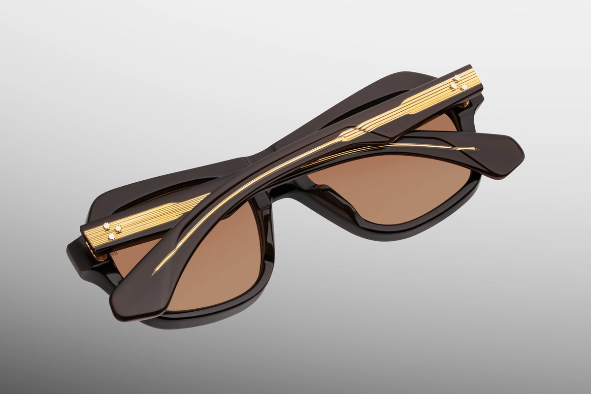 Inner rear view of Jacques Marie Mage Tamerlis Walnut sunglasses, showcasing the custom dark gold 7-barrel hinge with spur-shaped rivets and the limited-production batch number foil-stamped in gold on the interior temple arm.
