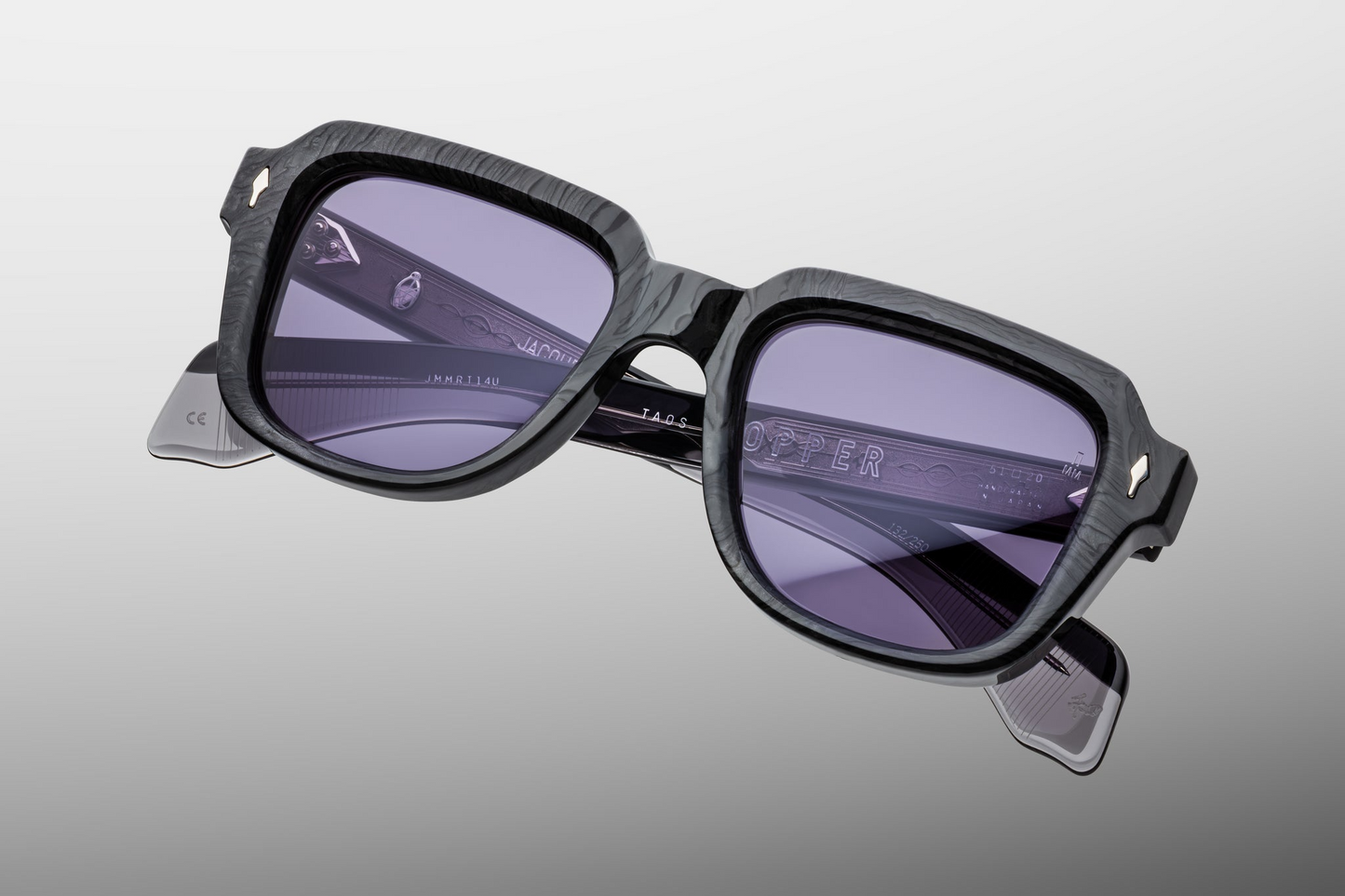 Side profile of Taos Ebony — thick double-laminated charcoal burlwood temples revealing exposed silver‑palladium wirecore and custom 7‑barrel stainless‑steel hinge