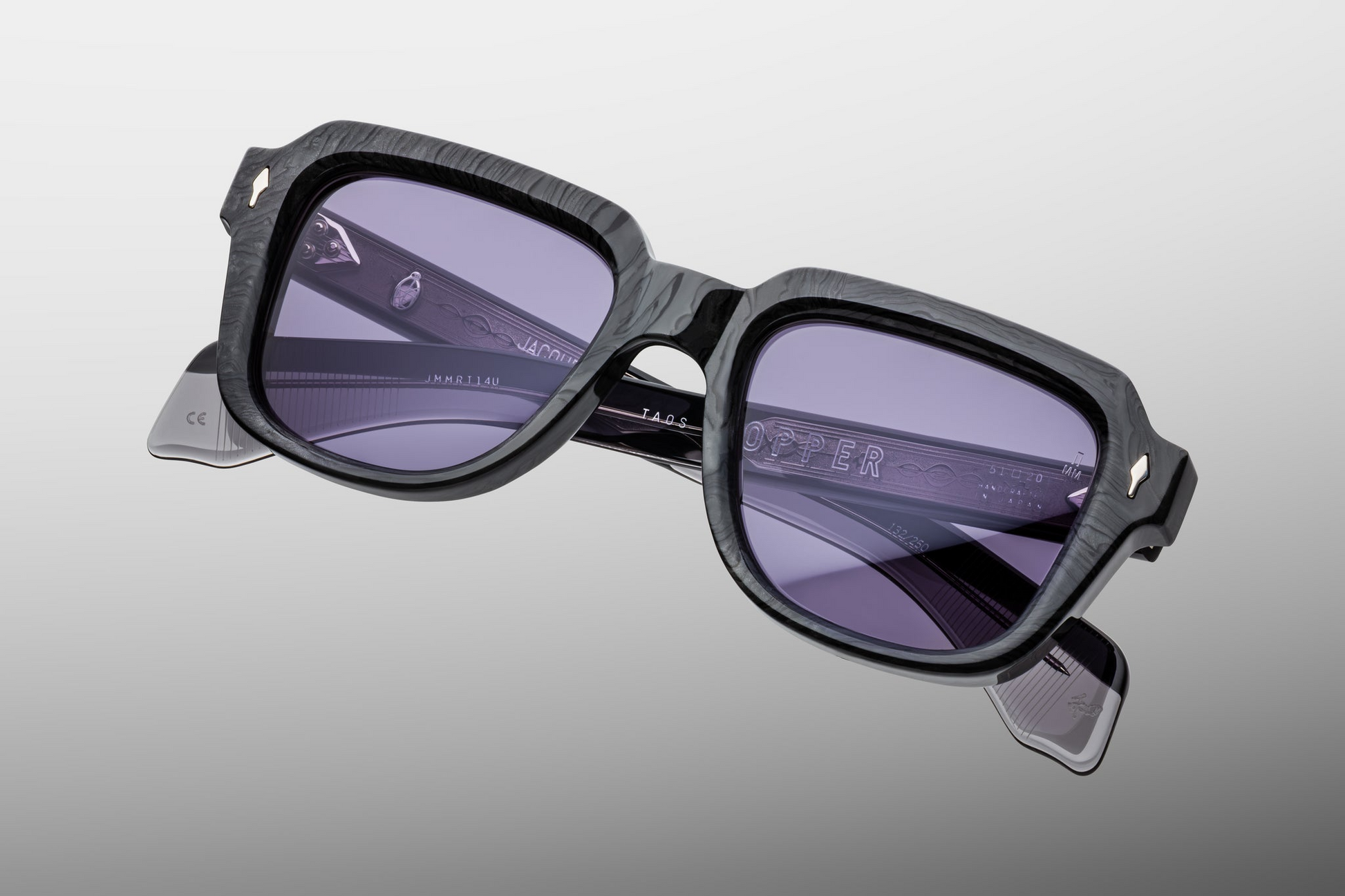 Side profile of Taos Ebony — thick double-laminated charcoal burlwood temples revealing exposed silver‑palladium wirecore and custom 7‑barrel stainless‑steel hinge