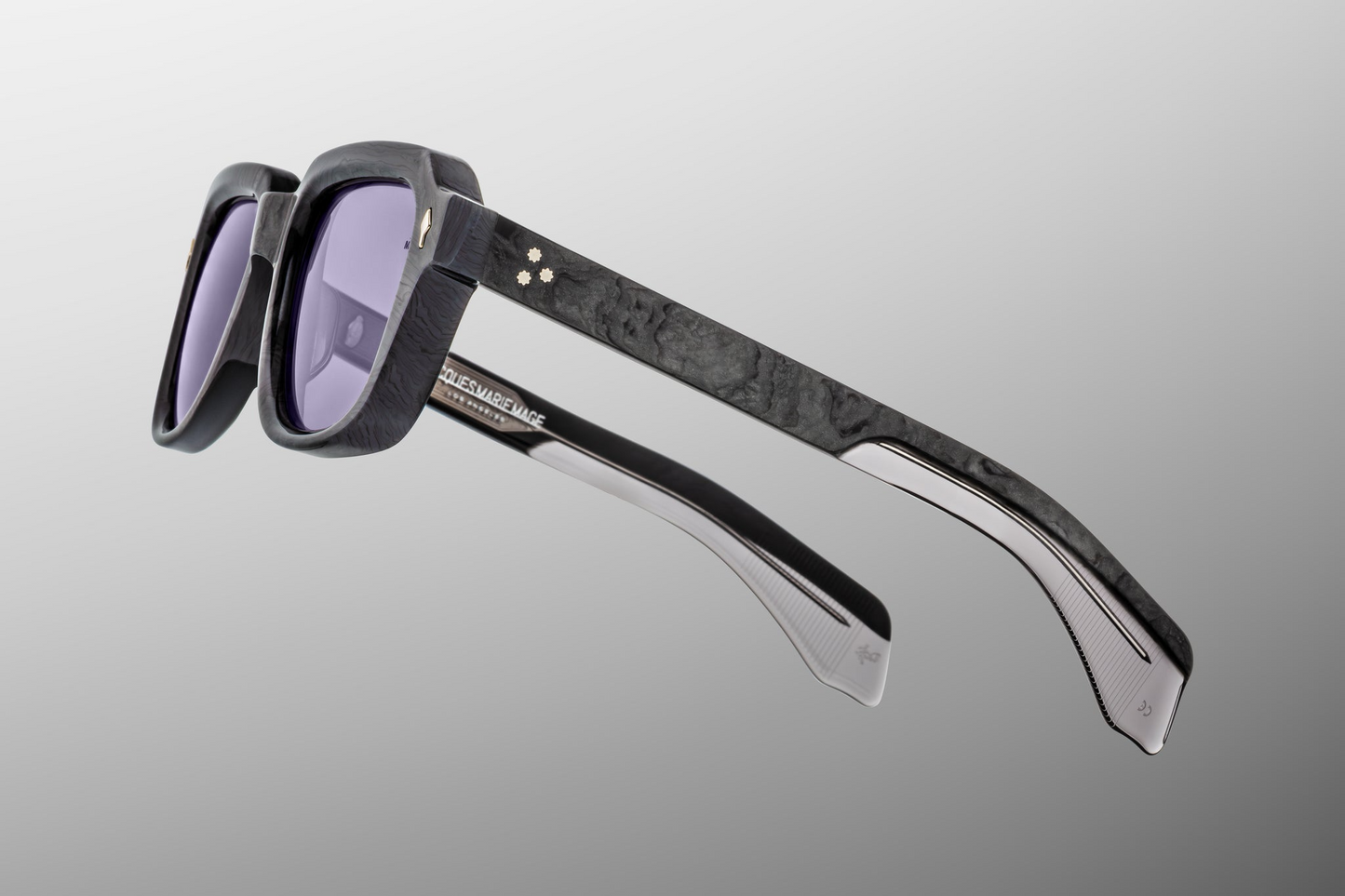 Side profile of Taos Ebony — thick double-laminated charcoal burlwood temples revealing exposed silver‑palladium wirecore and custom 7‑barrel stainless‑steel hinge