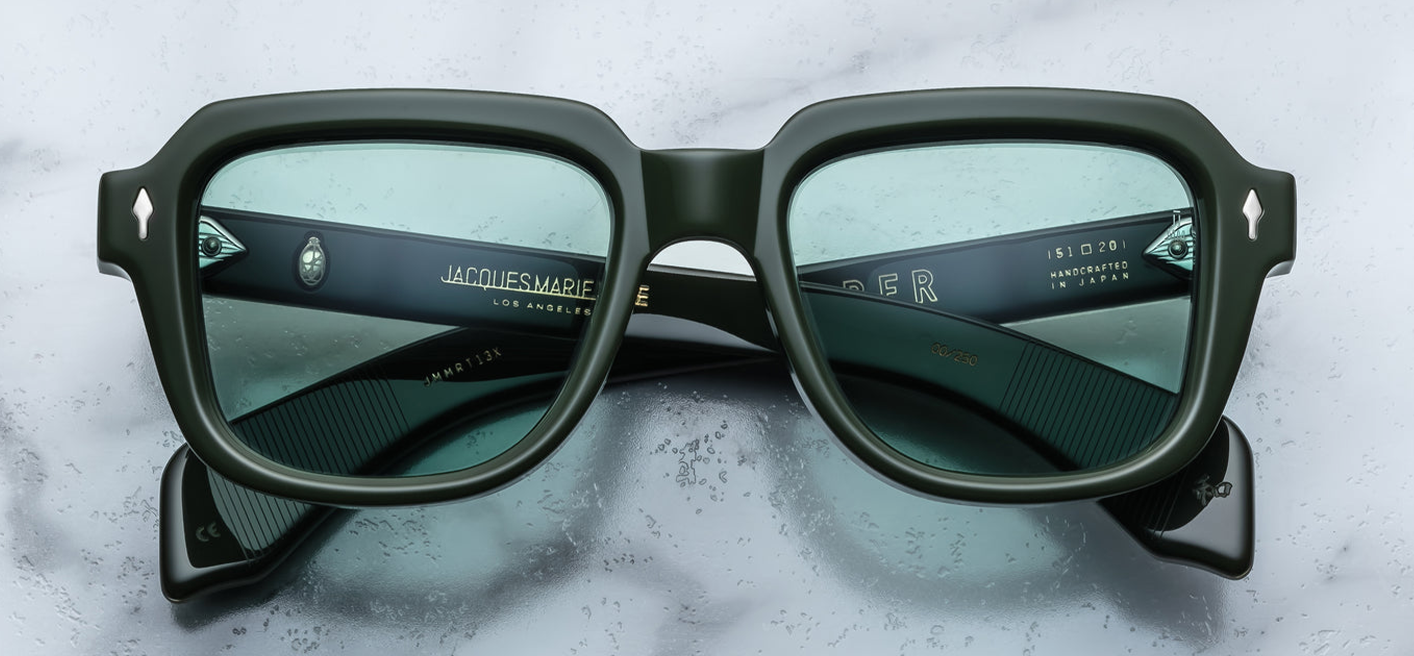 Front view of JMM TAOS Mink sunglasses: rectangular 10mm cured Japanese acetate frame in mink‑grey tone, 51mm lens width, prominent single‑bridge brow, gold arrowhead front pins