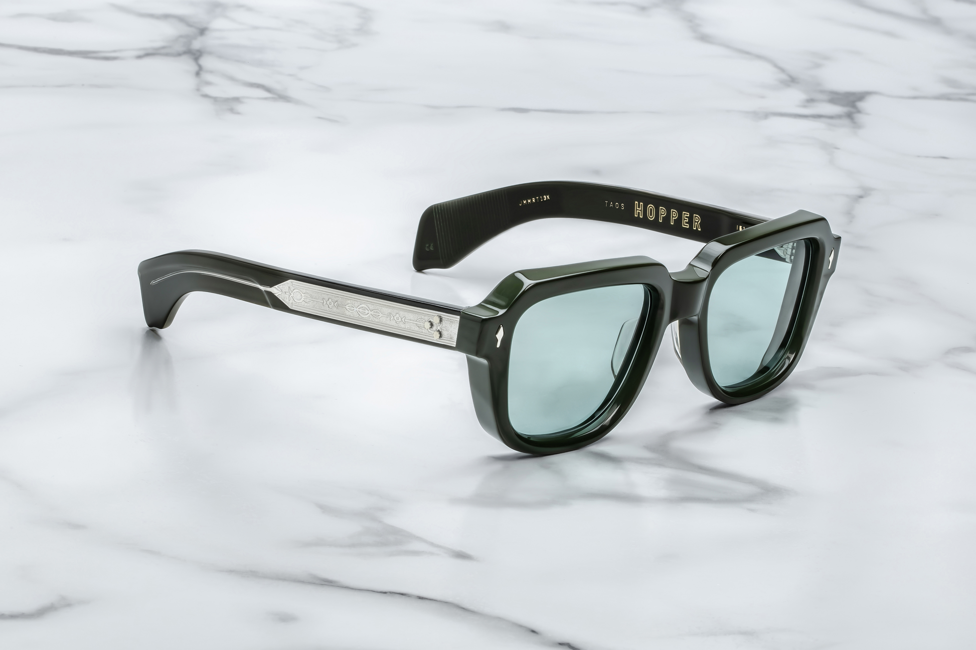 Side view of TAOS Mink by Jacques Marie Mage: thick double‑laminated mink acetate temples, exposed wire‑core detailing, triple spur rivets at hinge, gold hardware connectors