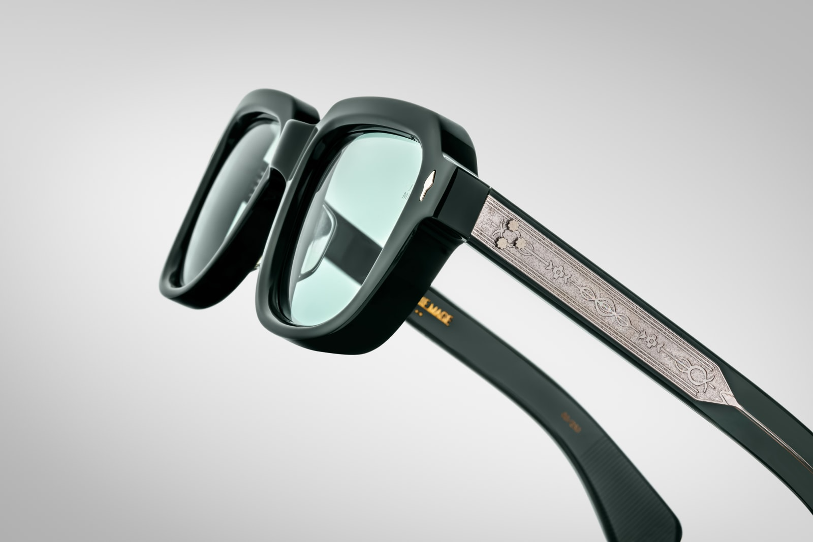 Side view of TAOS Mink by Jacques Marie Mage: thick double‑laminated mink acetate temples, exposed wire‑core detailing, triple spur rivets at hinge, gold hardware connectors
