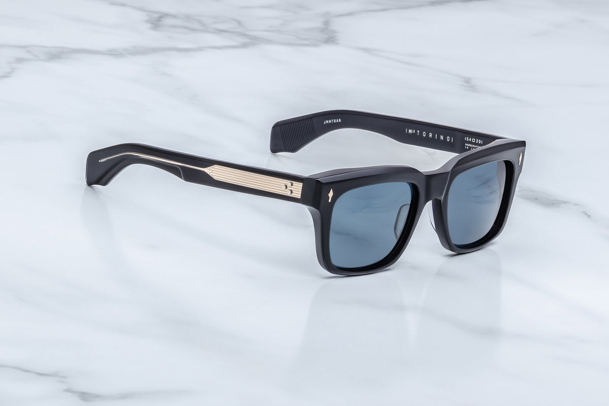 Three-quarter view of the Jacques Marie Mage Torino Lacquer sunglasses. This angle showcases the frame's distinct architectural lines and hand-polished angular beveling along the brow line, transitioning into thick sculptural temples.