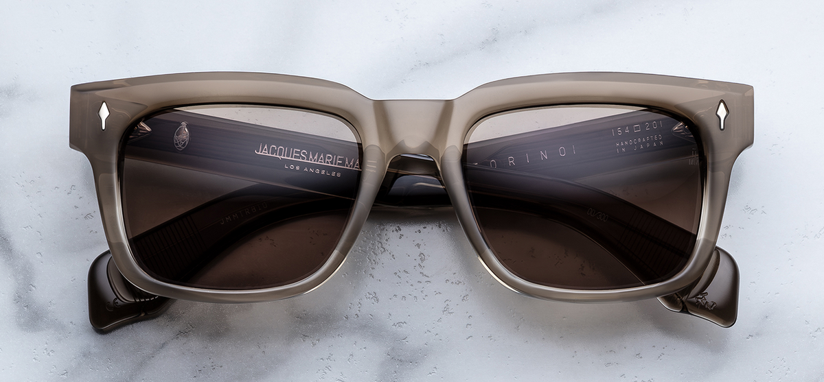 Front view of Jacques Marie Mage Torino Lescot sunglasses. Displays a bold, 1960s-inspired rectangular 10mm block acetate frame in a warm, polished tan-brown tortoiseshell blend, fitted with solid brass-tinted golden lenses and sterling silver arrowhead front pins.