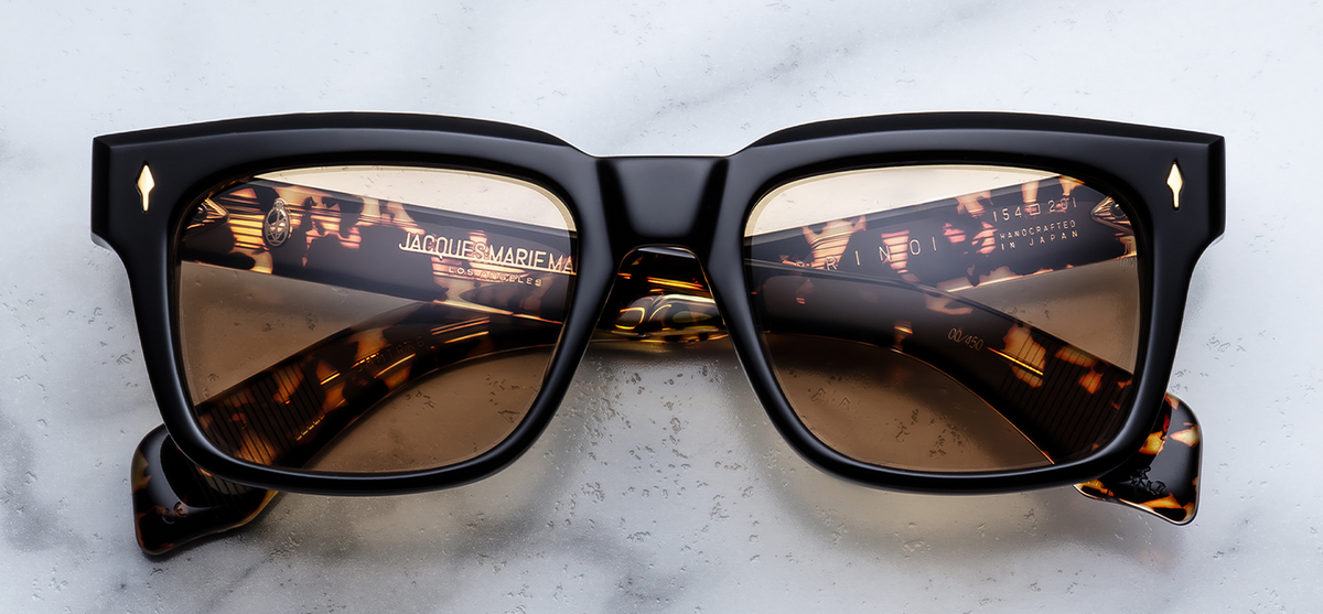  Front view of Jacques Marie Mage Torino Tavern sunglasses. Displays a bold, 1960s-inspired rectangular 10mm block acetate frame in a warm brown tortoiseshell blend, fitted with clear bronze-tinted lenses and dark gold arrowhead front pins.