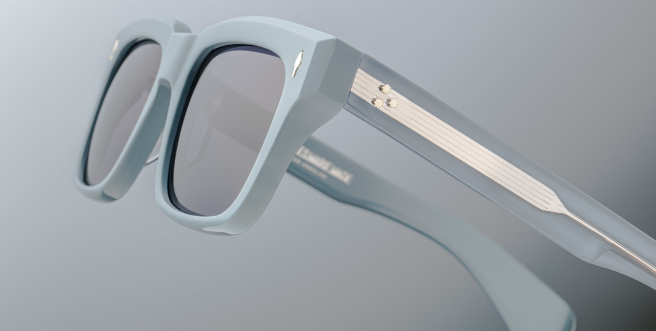 Profile of Jacques Marie Mage Molino Tiger — double-laminated blue acetate temples showing engraved silver core wire and custom 7-barrel hinge with rivets.