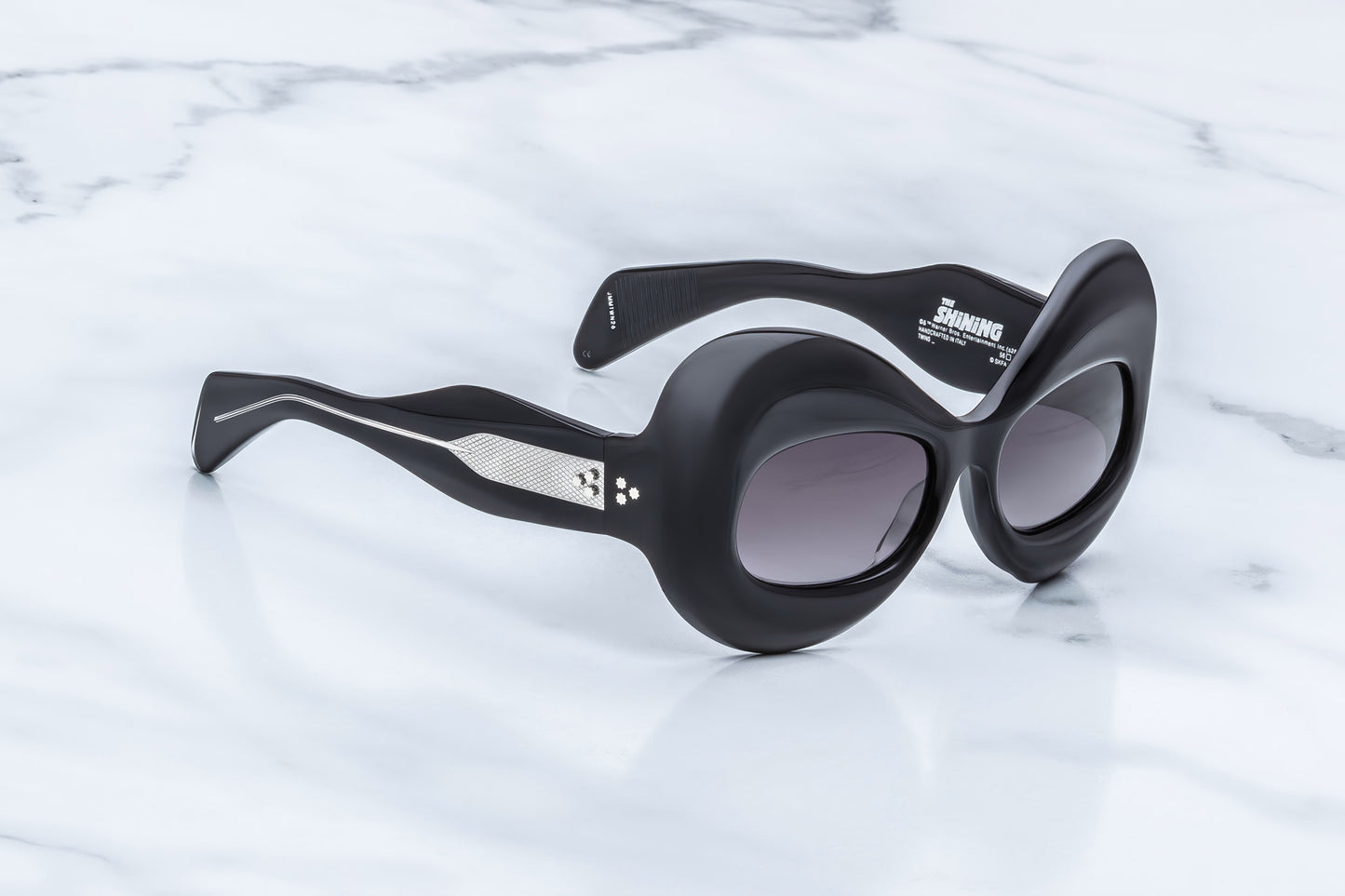 Jacques Marie Mage Twins Shadow side view showing thick black acetate temples, curved profile and exposed silver wirecore
Side profile of JMM Kubrick Twins Shadow sunglasses highlighting oversized butterfly shape and sculpted temples