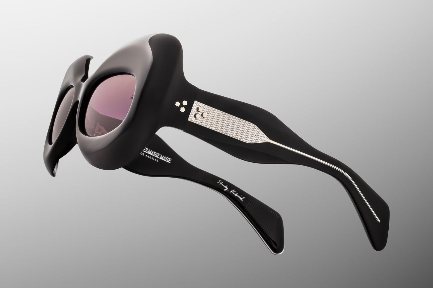 Close-up side detail of Jacques Marie Mage Twins Shadow showing engraved wirecore, 7-barrel hinge and layered acetate temples
Macro side view of JMM Twins Shadow sunglasses highlighting premium silver hardware and craftsmanship
