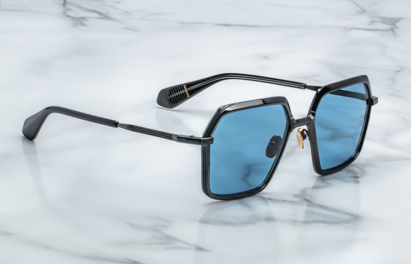 Side profile of Ugo Black — slim black titanium temple with hairline epoxy detail and black acetate temple tip