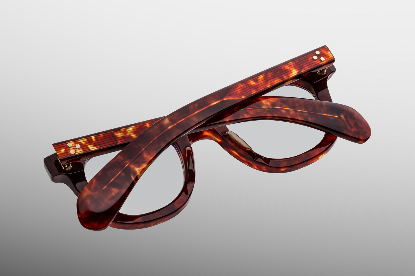 Rear of Vendome Breccia — inside of the temples showing the warm breccia laminate and the exposed silver wire-core