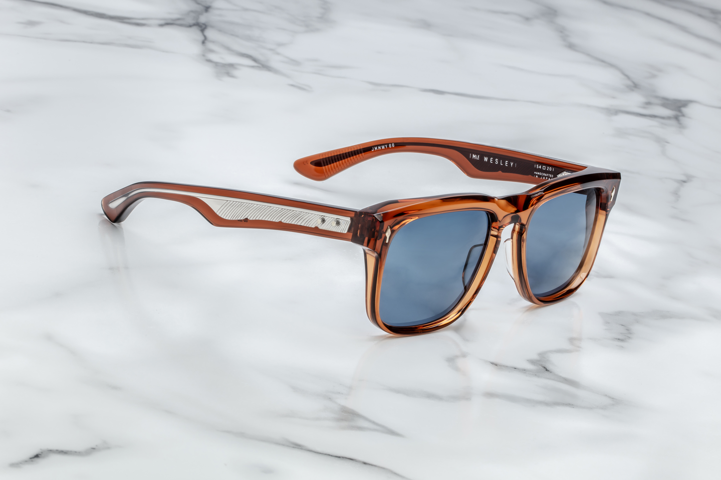 Side profile of Wesley Rootbeer — double-laminated brown acetate temple and exposed silver wire-core engraved in a feather motif