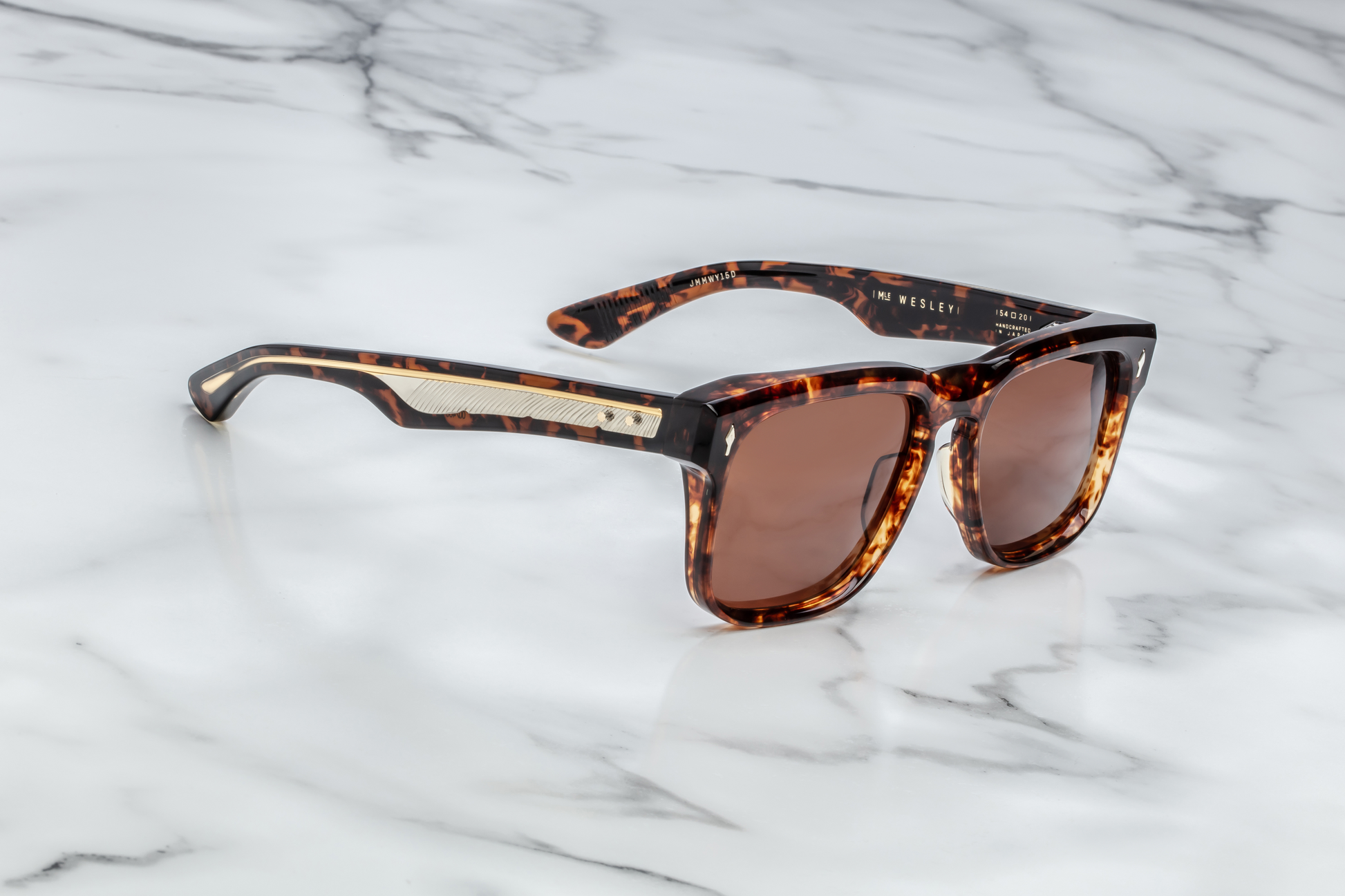Side profile of Wesley Samoa — layered Havana acetate temple showing exposed dark-gold wire-core with feather engraving