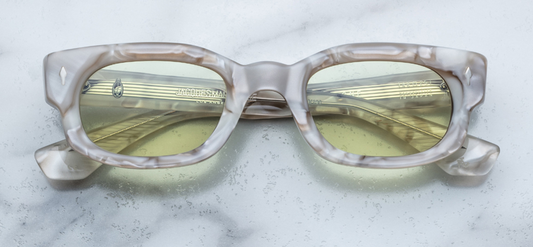 Straight-on view of Jacques Marie Mage Whiskeyclone sunglasses in Himalaya—a striking blend of milky white and pale turquoise Japanese cellulose acetate. The medium rectangular frame features a polished full-rim with softly rounded edges and a pronounced saddle bridge. Silver arrowhead pins are inset at the upper corners, contrasting elegantly with the cool marbled pattern