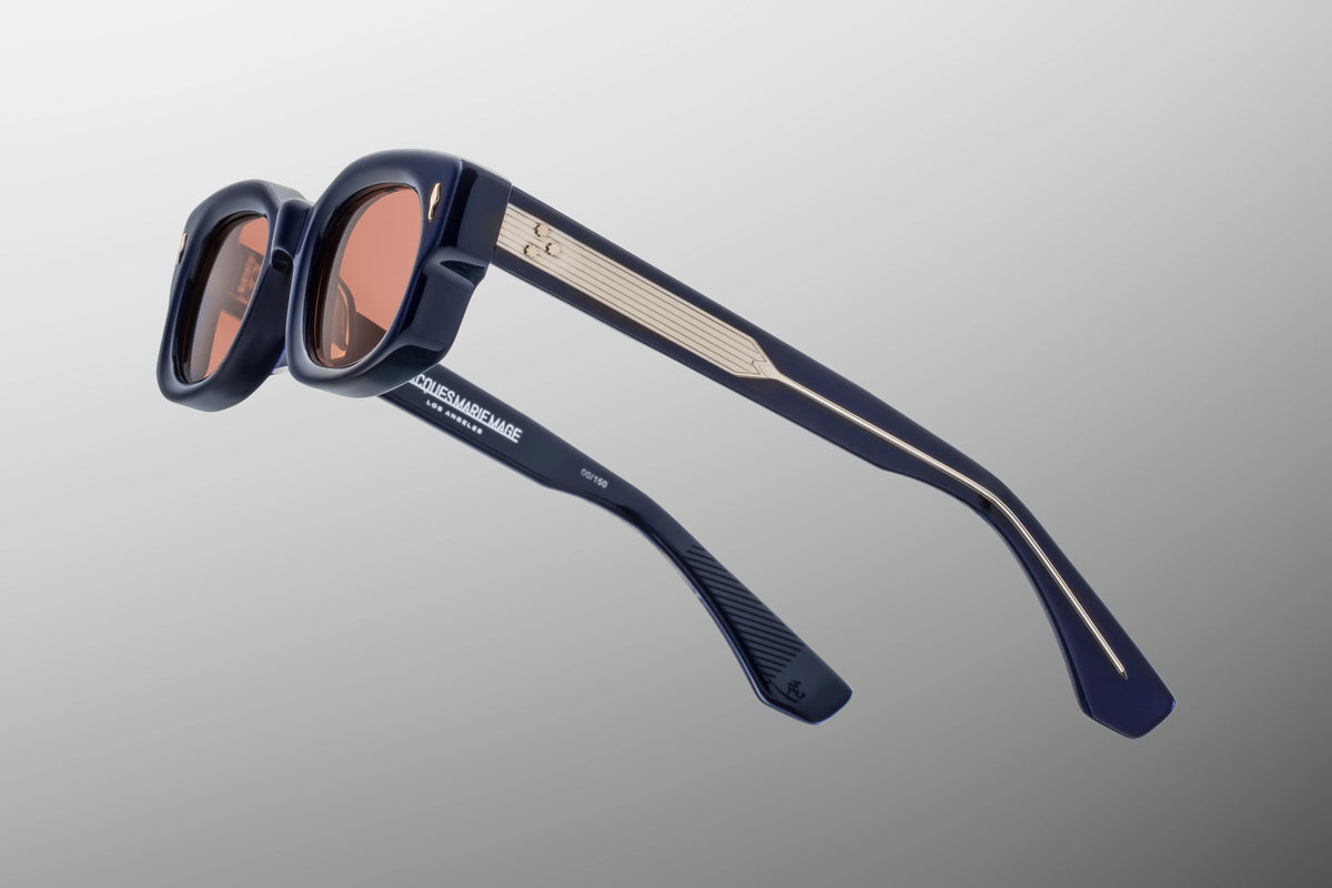 Focused close-up of the temple arms of the Whiskeyclone Minuit glasses. The image highlights the exposed silver metal inner wirecore featuring intricate, custom hairline engravings that shimmer through the clear interior laminate of the dark blue-black acetate arm
