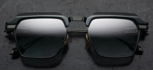 Black sunglasses with reflective lenses on a dark textured background