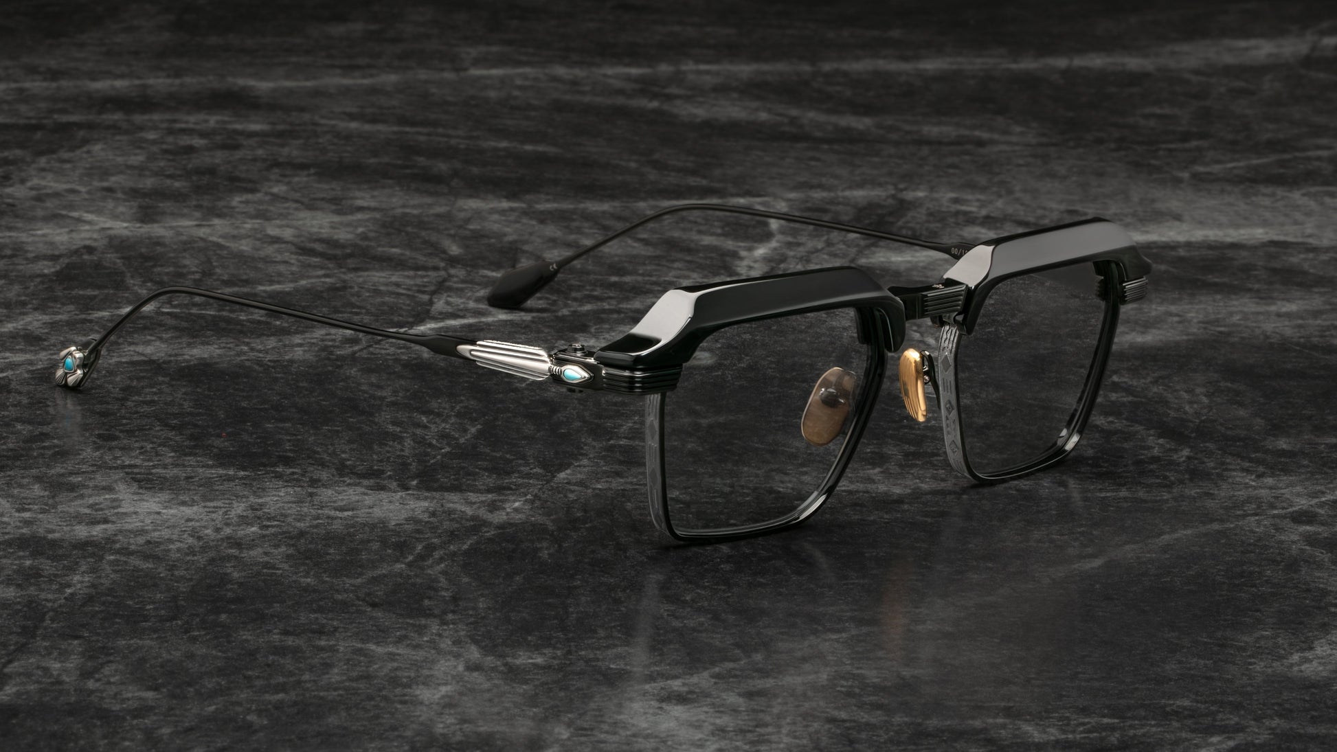 Black eyeglasses on a textured dark surface