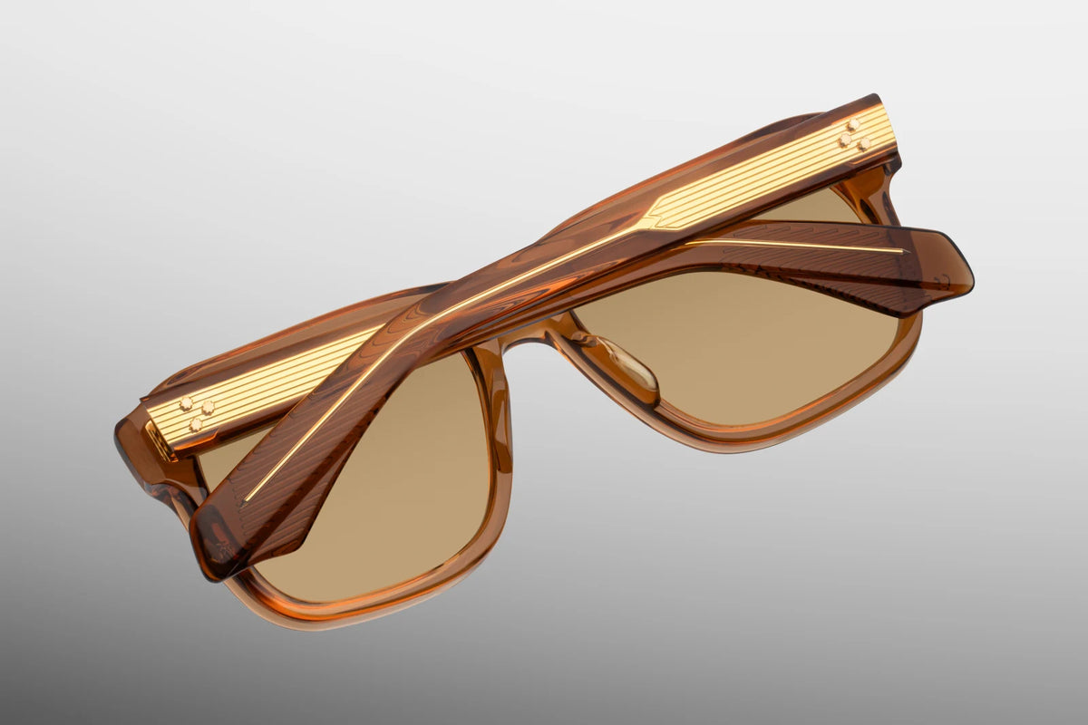  Close-up interior detail shot of the Jacques Marie Mage Yves Solaris frame architecture. The inner view highlights the translucent golden-amber rims against the premium 18K dark gold metallic hardware components. Crisp gold foil-stamped text on the inner temple arm indicates the rare limited-edition serial number out of the exclusive global batch of 150 alongside the "Handcrafted in Japan" production text. Available at WINK Optometrists.