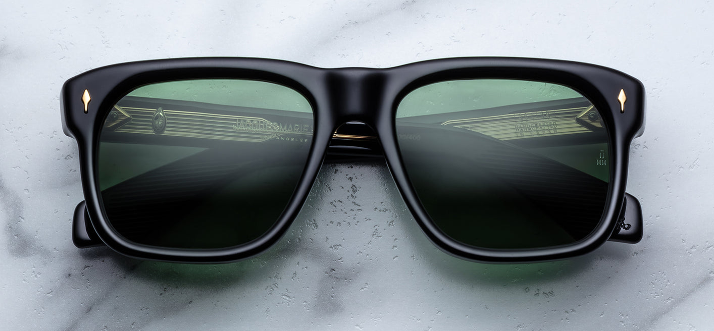 Front of JMM Yves Venom — bold rectangular frame in deep black cured acetate, with wide bridge and green emerald CR39 lenses