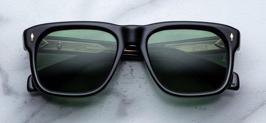 Front of JMM Yves Venom — bold rectangular frame in deep black cured acetate, with wide bridge and green emerald CR39 lenses