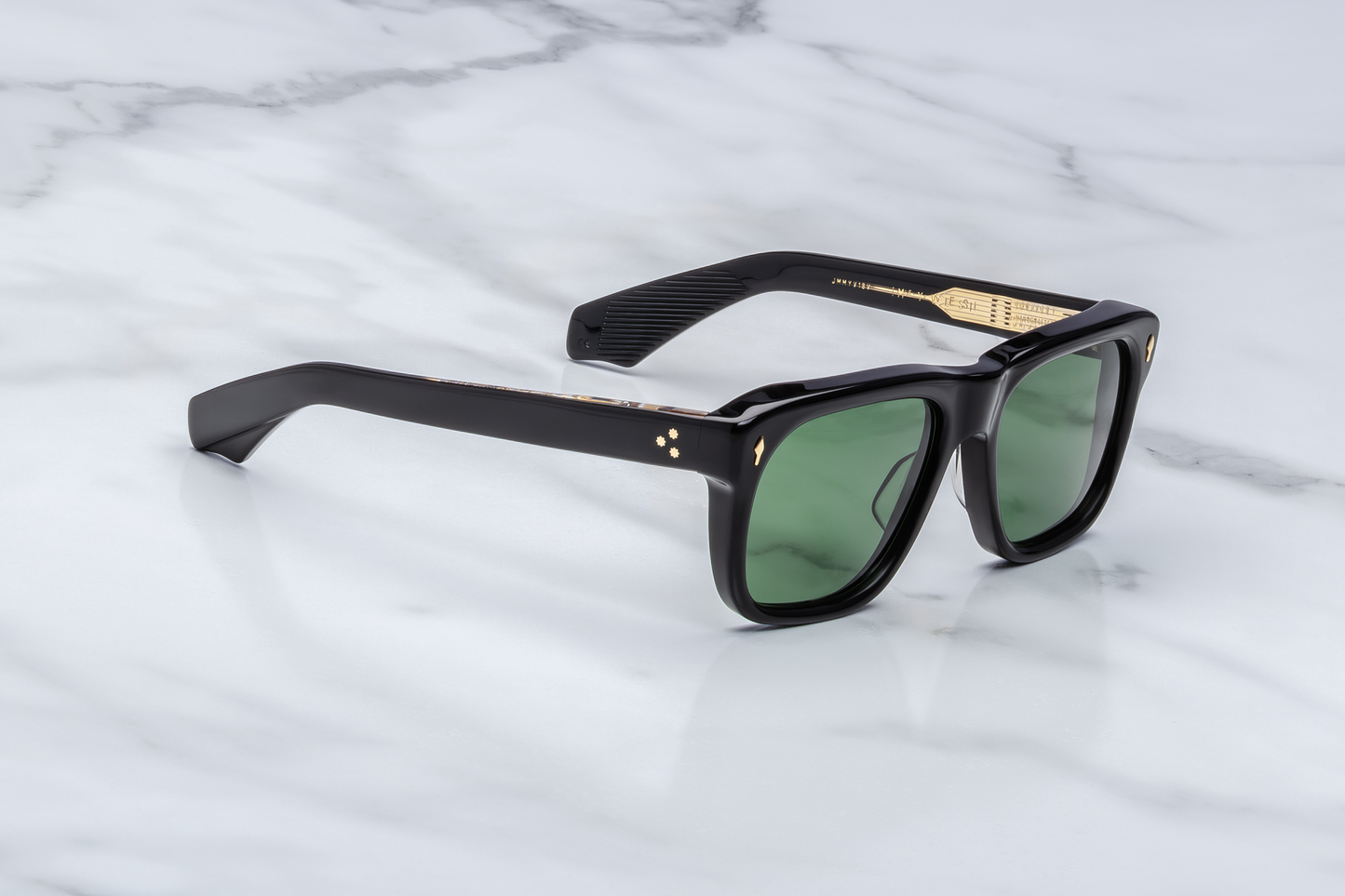 Three-quarter angle of Yves Venom — showing the blocky 10 mm black acetate frame, gently sloping temples, and rich green lenses