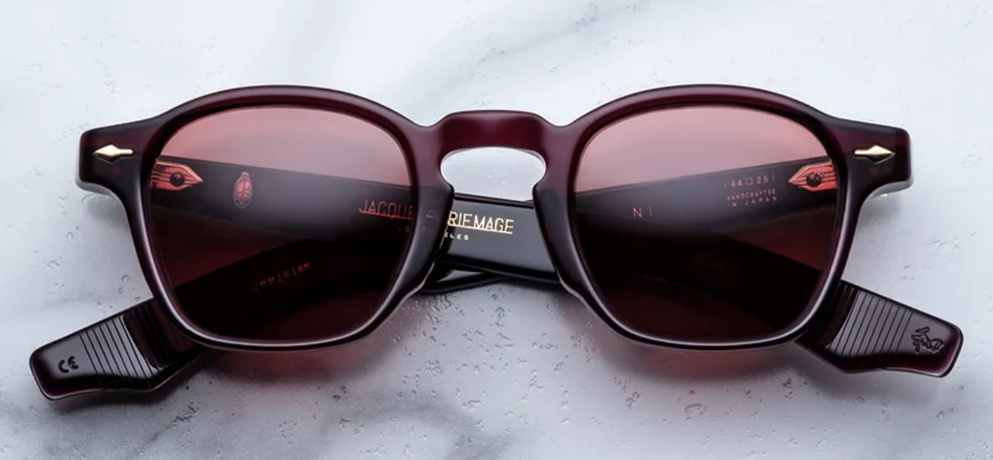 Front studio view of Jacques Marie Mage Zephirin sunglasses in Amarena, showcasing a square 1940s-style frame in polished deep cherry-red acetate with matching translucent red lenses and dark gold arrowhead pins