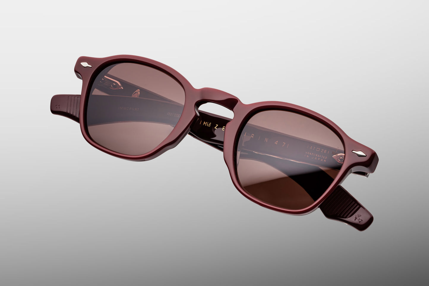  Top-down view of the JMM Zephirin Bordeaux Empire frame, revealing the sleek top line profile of the deep red acetate brow line, integrated nose contours, and custom dark gold 5-barrel hinges.