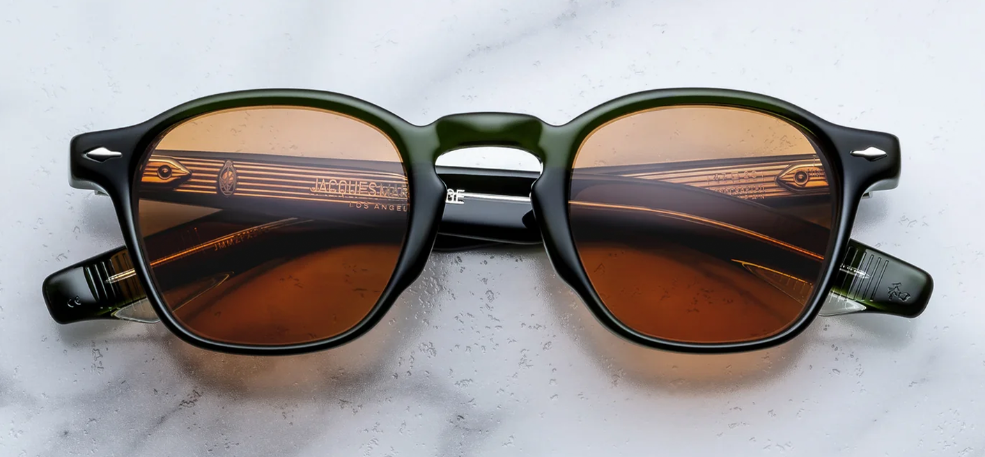 Front studio view of Jacques Marie Mage Zephirin sunglasses in Borneo, showcasing a square 1940s-style frame in polished olive-green acetate with vibrant orange lenses and sterling silver arrowhead front pins.