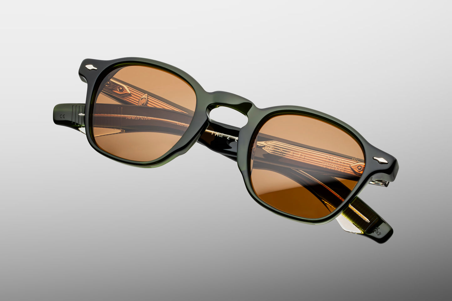 Top-down view of the JMM Zephirin Borneo frame, revealing the top-line profile of the substantial green acetate brow line, sculpted nose contours, and custom silver 5-barrel hinges.