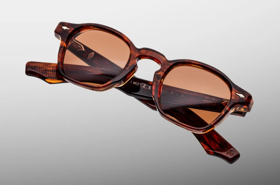 Top-down view of the JMM Zephirin Bourbon frame, revealing the top-line profile of the substantial tortoise shell brow line, integrated nose contours, and custom silver 5-barrel hinges.