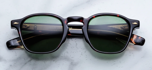 Front studio shot of Jacques Marie Mage Zephirin sunglasses in Etna, showing a rectangular 1940s-style frame in polished Havana tortoise shell acetate with dark green lenses and 18k dark gold arrowhead front pins.