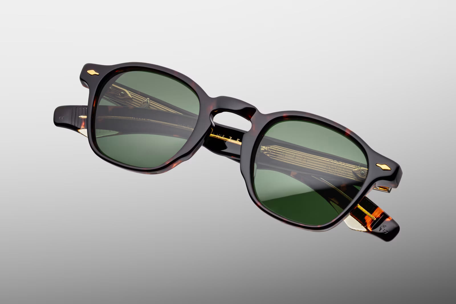 Top-down view of the JMM Zephirin Etna frame, revealing the sleek top line profile of the thick tortoise shell brow line, integrated nose contours, and custom dark gold 5-barrel hinges.