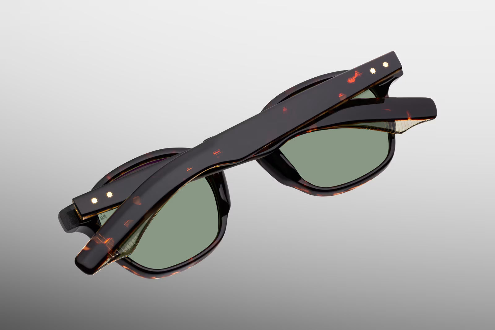 Rear perspective of the JMM Zephirin Etna temples, detailing the curved ear bends where the rich Havana tortoise shell exterior transitions to a crystal-clear inner laminate to showcase the internal gold-plated wirecore tips.