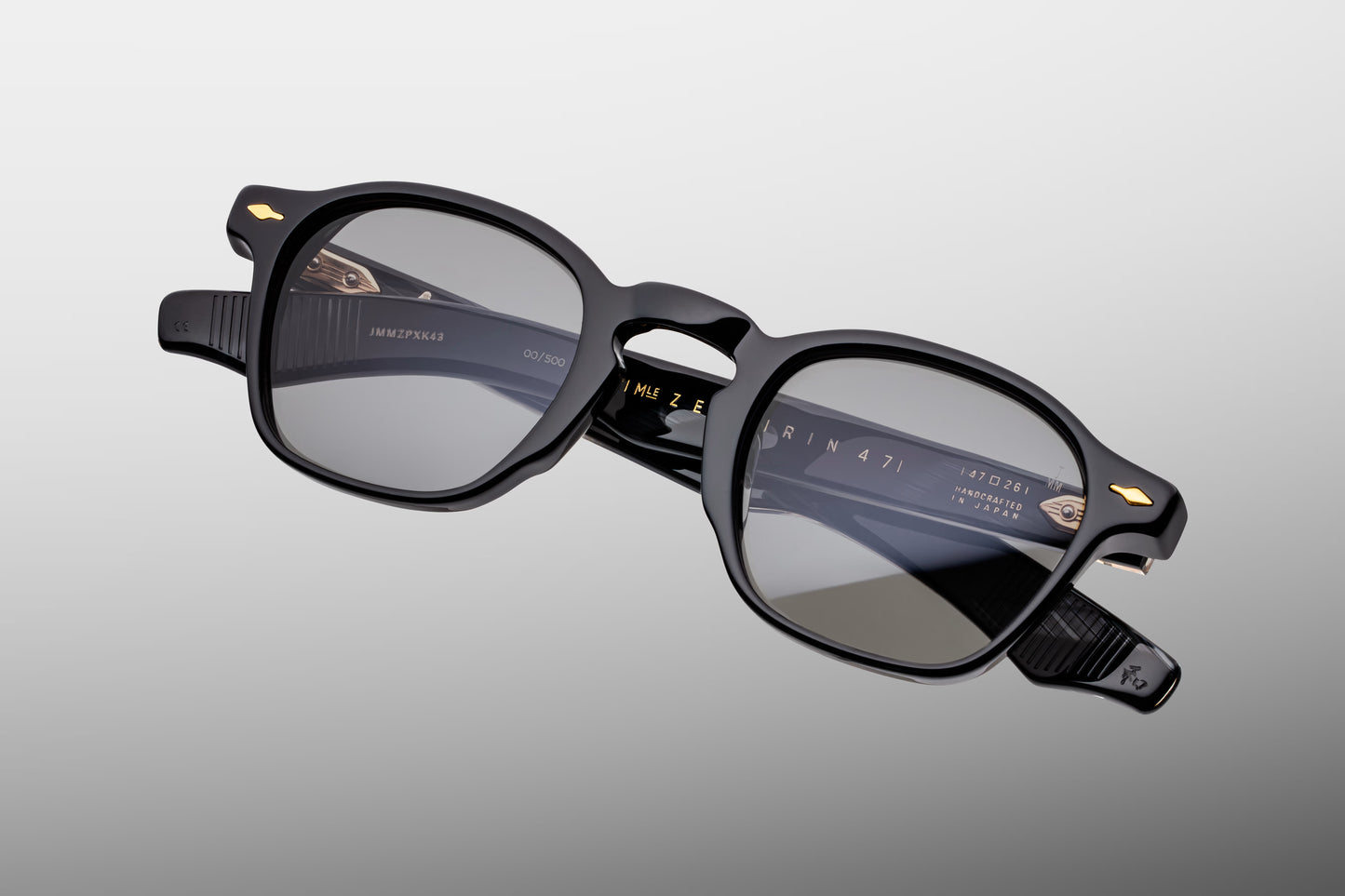 Top-down view of the JMM Zephirin Griffin frame, revealing the sleek top line profile of the thick black acetate brow line, integrated nose contours, and custom gold-finished 5-barrel hinges.
