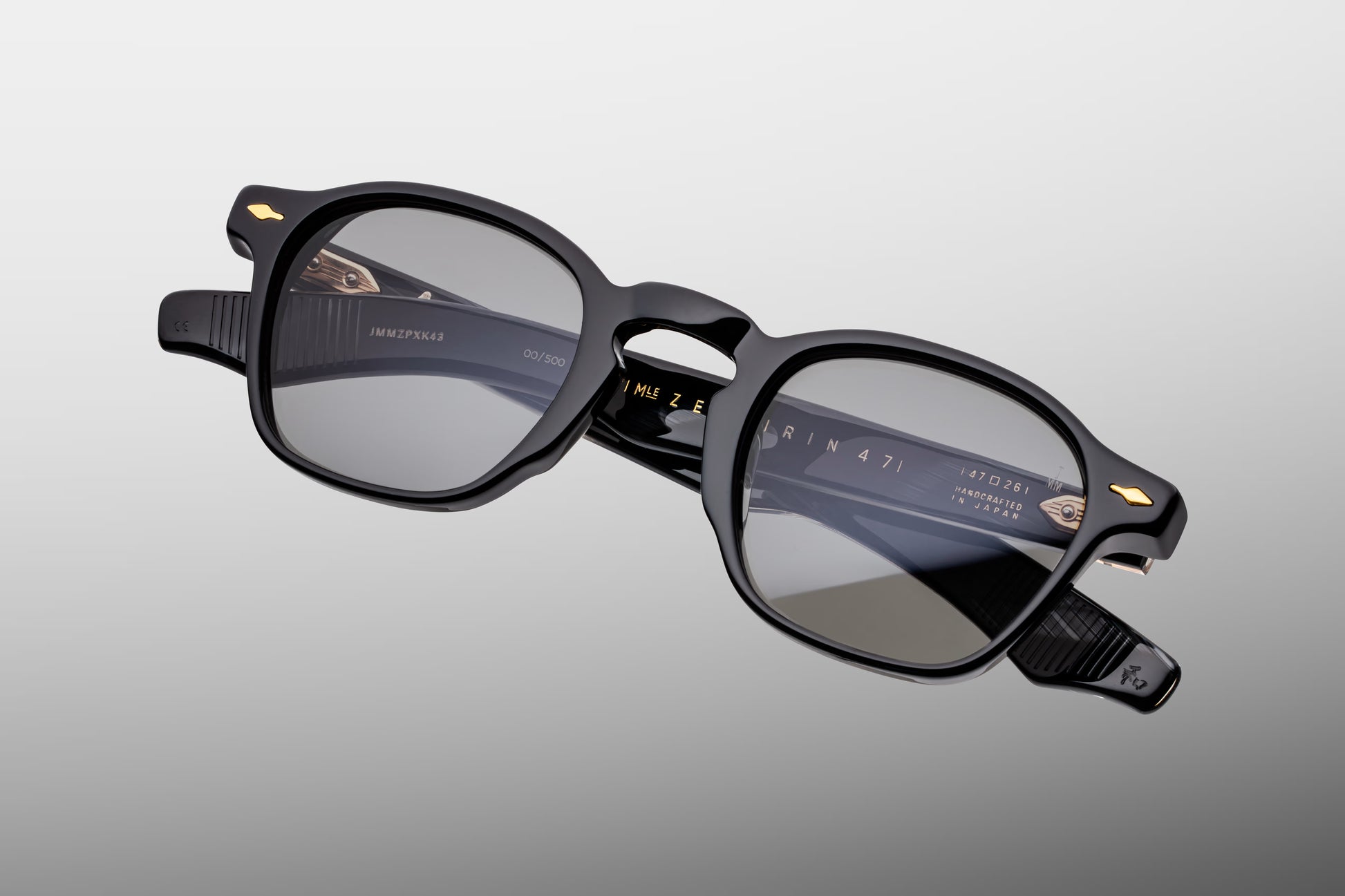 Top-down view of the JMM Zephirin Griffin frame, revealing the sleek top line profile of the thick black acetate brow line, integrated nose contours, and custom gold-finished 5-barrel hinges.