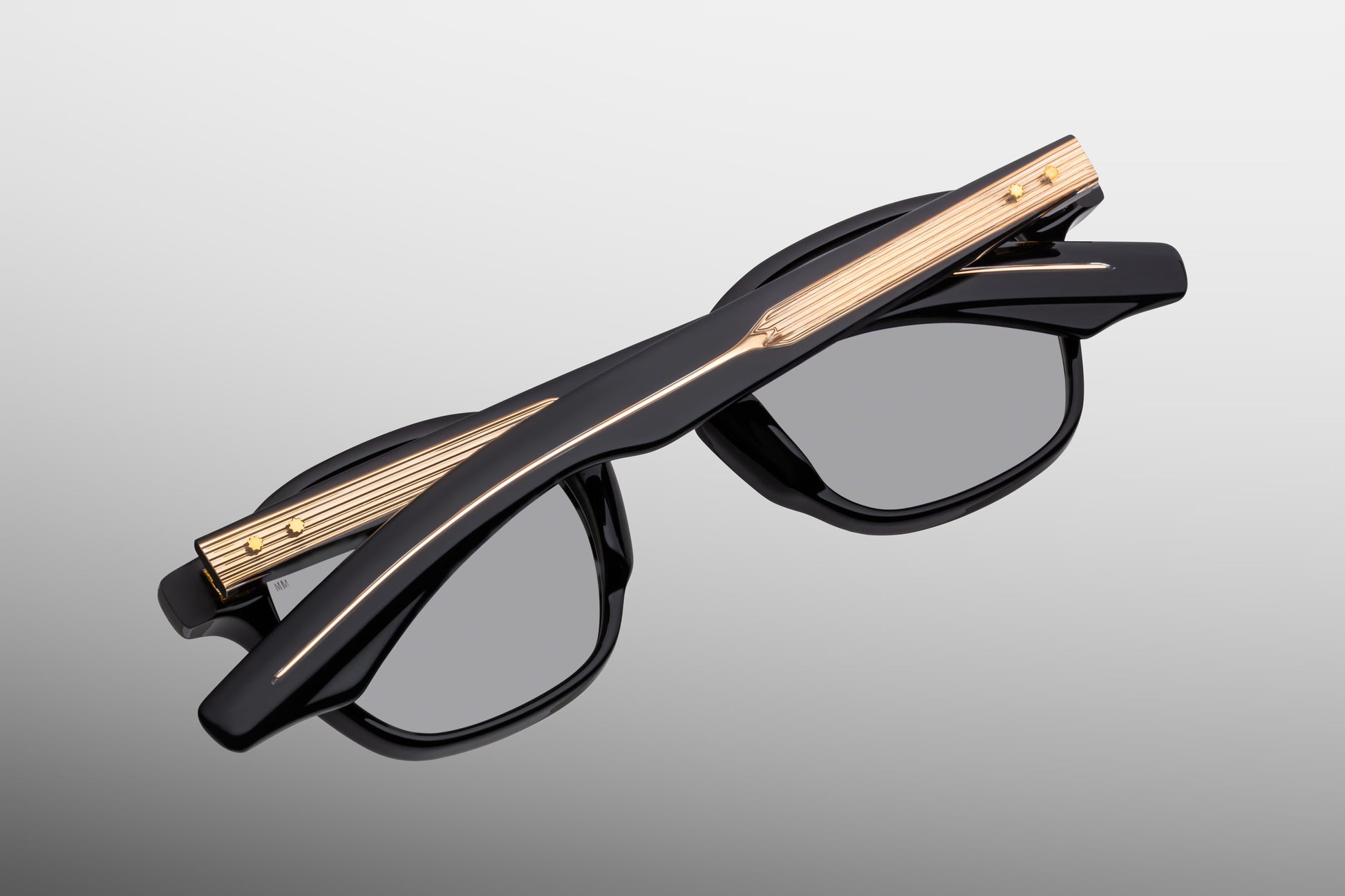 Rear perspective of the JMM Zephirin Griffin temples, detailing the curved ear bends where the rich black exterior transitions to a translucent inner laminate to showcase the internal gold-plated wirecore tips.