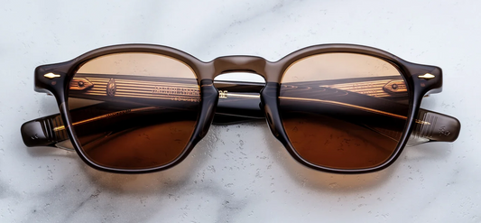 Front studio shot of Jacques Marie Mage Zephirin sunglasses in London brown acetate, showcasing a square 1940s-style frame with a keyhole bridge, solid G15 green lenses, and 18k light gold arrowhead front pins.