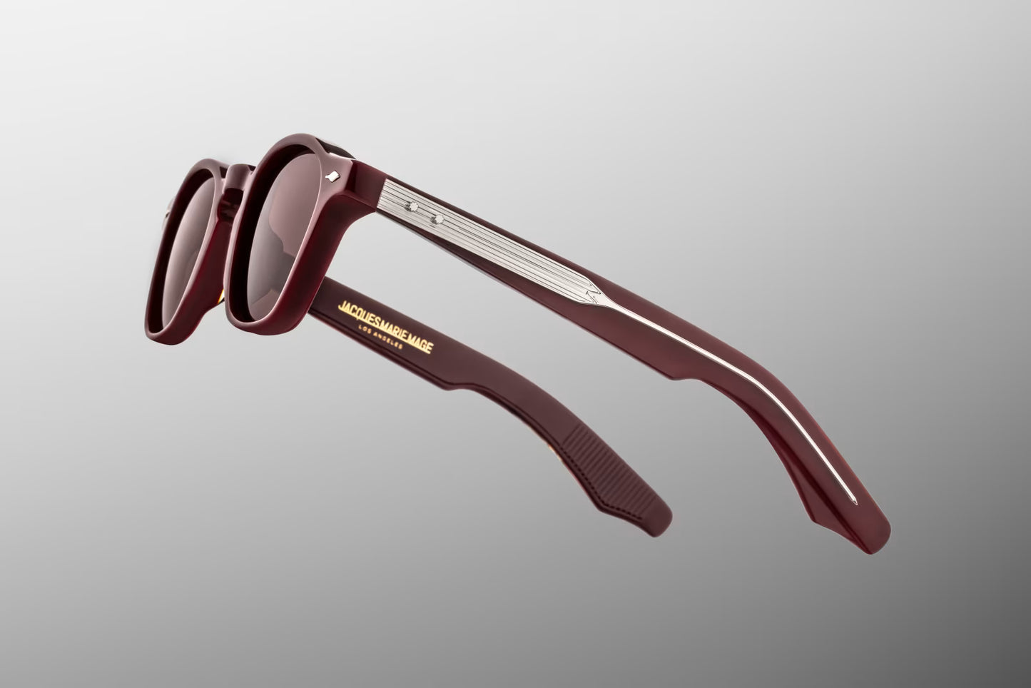 Close-up of Jacques Marie Mage Zephirin Bordeaux Empire temple featuring exposed silver wirecore, custom hairline engraving and sterling silver arrowhead hardware
