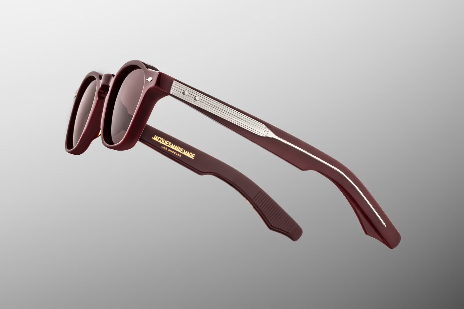 Close-up of Jacques Marie Mage Zephirin Bordeaux Empire temple featuring exposed silver wirecore, custom hairline engraving and sterling silver arrowhead hardware