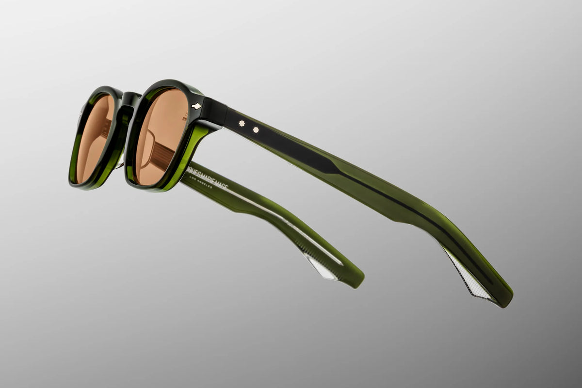 Side profile view of the Zephirin 47 in Borneo, displaying the wide custom double-laminated green acetate temples, silver spur-shaped rivets on the hinge, and the exposed custom silver wirecore with hairline engravings