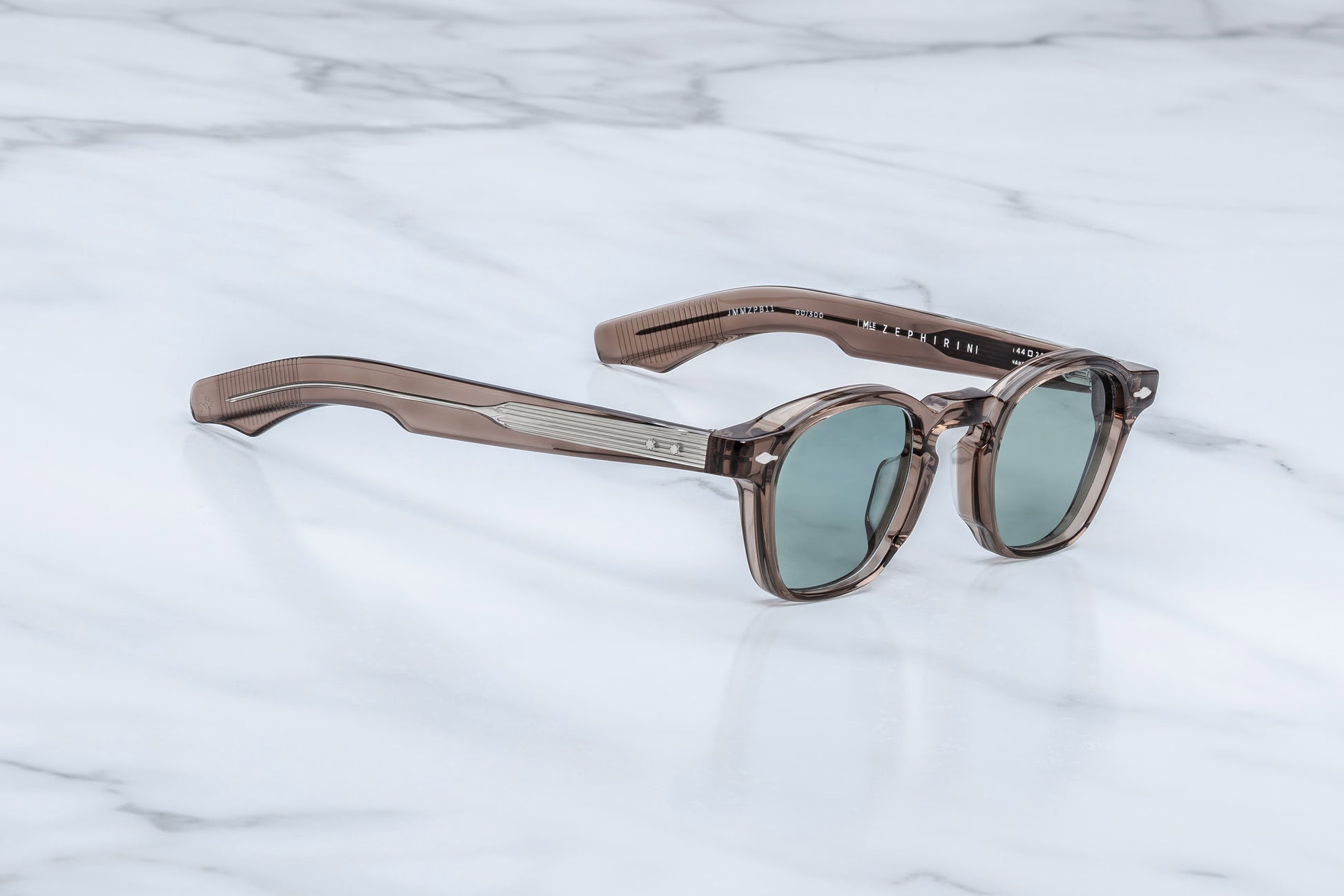 Side profile of Jacques Marie Mage Zephirin Dusty Jade sunglasses showcasing sculpted temples, custom metal hinges, and translucent dusty jade green acetate construction