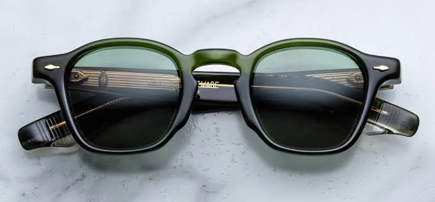 Front studio view of Jacques Marie Mage Zephirin sunglasses in Kombu, showcasing a classic square 1940s-inspired frame in translucent dark forest-green acetate with matching solid green lenses and silver arrowhead pins