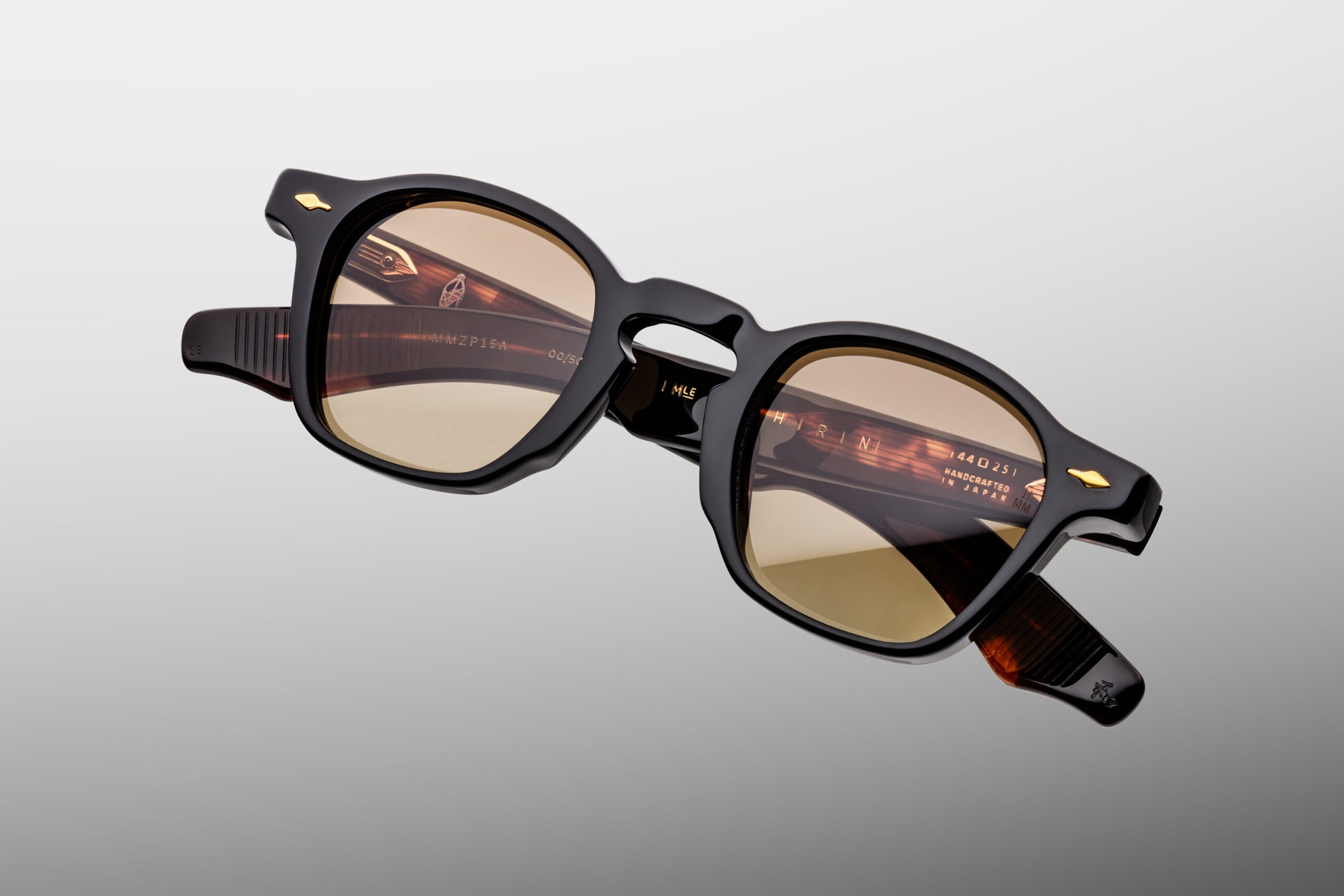 Close-up front view of Jacques Marie Mage Zephirin Noir 15 sunglasses featuring the signature Zephirin P3 shape, polished jet-black acetate and brass gradient CR39 lenses